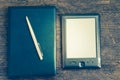 Black ereader with notebook and ink pen