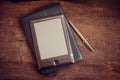 Black ereader with notebook and ink pen