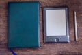 Black ereader with notebook and ink pen