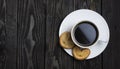 black espresso coffee from ground beans with heart-shaped cookies on a dark wooden background with copy space Royalty Free Stock Photo