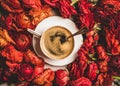 Black espresso coffee in white cup on red flower background Royalty Free Stock Photo