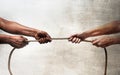 Black ethnicity arms with hands pulling rope against white Caucasian race person in stop racism and xenophobia concept Royalty Free Stock Photo