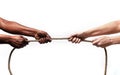 Black ethnicity arms with hands pulling rope against white Caucasian race person in stop racism and xenophobia concept Royalty Free Stock Photo