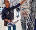 Black ethnicity man buying newspaper reporting handover ceremony