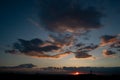 Black evening clouds at sunset. Clouds beat off red sunset light from the sun Royalty Free Stock Photo