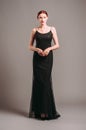 Black evening dress. Elegant lady in full-length multilayer sleeveless vintage gown with straps