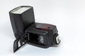 Black external flash for a camera with an open battery compartment. Royalty Free Stock Photo