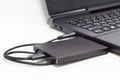 Black external hard drive connect to laptop computer Royalty Free Stock Photo