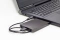 Black external hard drive connect to laptop computer Royalty Free Stock Photo
