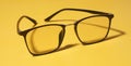 Black eye glasses isolated on yellow background Royalty Free Stock Photo