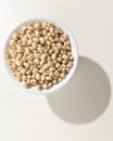 Black Eyed Pea legume. Grains in a bowl. Shadow over white table Royalty Free Stock Photo