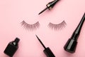 Black eyelashes and mascara on pink background with copy space Royalty Free Stock Photo