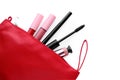 Black eyeliner and other makeup products in cosmetic bag on white background, top view Royalty Free Stock Photo