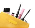 Black eyeliner and other makeup products in cosmetic bag on white background, top view Royalty Free Stock Photo