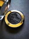 Black eyeshadows on a black background, close up. Royalty Free Stock Photo