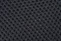 Black fabric texture with pattern, with sagging inside the ovals. The texture of the fabric