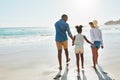 Black family, beach and walk during summer on vacation or holiday relaxing and enjoying peaceful scenery at the ocean Royalty Free Stock Photo