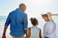 Black family, beach and walking during summer on vacation or happy holiday laughing and enjoying the scenery at the Royalty Free Stock Photo