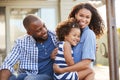 Black family embracing outdoors smiling to camera outside Royalty Free Stock Photo