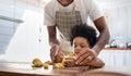 Black family having fun prepare bakery together at home. African American father and adorable son kneading dough in kitchen. Happy Royalty Free Stock Photo