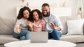 Black family having video call using laptop waving hands Royalty Free Stock Photo