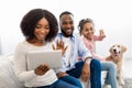 Black family having videocall using laptop waving hands Royalty Free Stock Photo