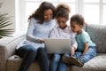 Black family mom with kids using laptop together at home