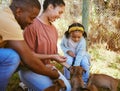 Black family, mother and father with child, puppies and playful together outdoor. African American parents, girl and