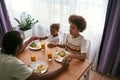 Black family praying together at breakfast at home Royalty Free Stock Photo