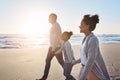 Black family, sunset and walking on the beach by happy child and parents on vacation or holiday. Sea, ocean and travel Royalty Free Stock Photo