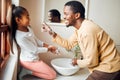 Black family, washing hands and health care with soap to clean in home bathroom. Man teaching girl while cleaning body Royalty Free Stock Photo
