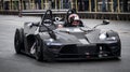 A black fast sports car drives on a racing circuit in Brno, Czech Republic.