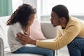 Black father comforting his crying kid, home interior Royalty Free Stock Photo