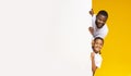 Black Father And Daughter Peeking Out Of White Advertisement Board Royalty Free Stock Photo