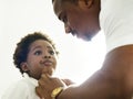 Black father dressing up his child Royalty Free Stock Photo