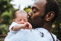 Black father kissing his mixed race baby boy Royalty Free Stock Photo