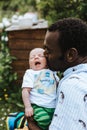 Black father kissing his mixed race baby boy Royalty Free Stock Photo