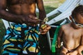 Black father offers his son a kiwi fruit and he rejects Royalty Free Stock Photo