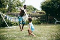 Black father playing with his son outside on a summers day