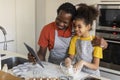 Black Father Using Digital Tablet While Baking With Daughter At Home Royalty Free Stock Photo