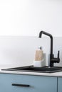 Black faucet over modern sink in kitchen interior Royalty Free Stock Photo