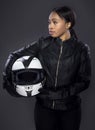Black Female Biker In Leather Jacket Holding A Helmet