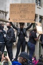 UK, London, 6/6/2020 - A black female Black Lives matter protestor bowing her head and holding a banner for George Floyd on Parlia