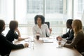 Black female boss leading corporate meeting talking to diverse b Royalty Free Stock Photo