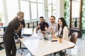 Black female boss leading corporate multiracial team meeting talking to diverse businesspeople. African american woman executive Royalty Free Stock Photo