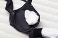 black female bra with cotton wool inside. Small female breast concept, female breast augmentation, close-up