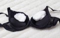 black female bra with cotton wool inside. Small female breast concept, female breast augmentation, close-up