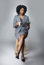 Black Female Businesswoman Keynote Speaker Posing with a Tablet and Coffee