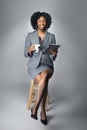 Black Female Businesswoman Keynote Speaker Posing with a Tablet and Coffee