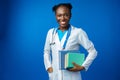 Black female doctor student wearing a lab coat with book Royalty Free Stock Photo